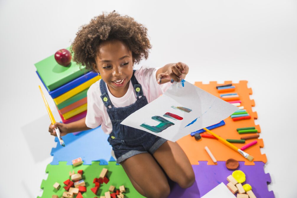 girl with painted paper play mat studio